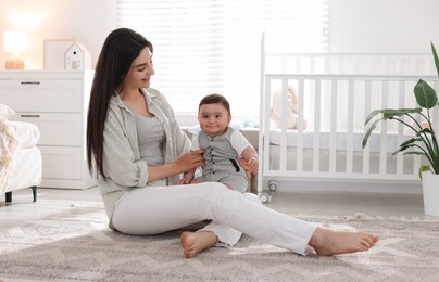 Photo of Mother with her cute baby at home. Space for text