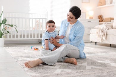 Photo of Mother with her cute baby at home