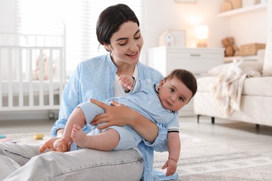 Photo of Mother with her cute baby at home