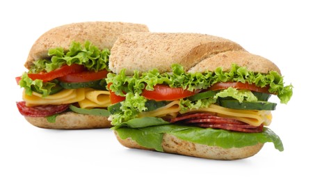 Photo of Pieces of tasty baguette sandwich with smoked sausage, cheese and vegetables isolated on white