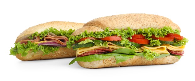 Photo of Tasty baguette sandwiches with smoked sausage, cheese and vegetables isolated on white