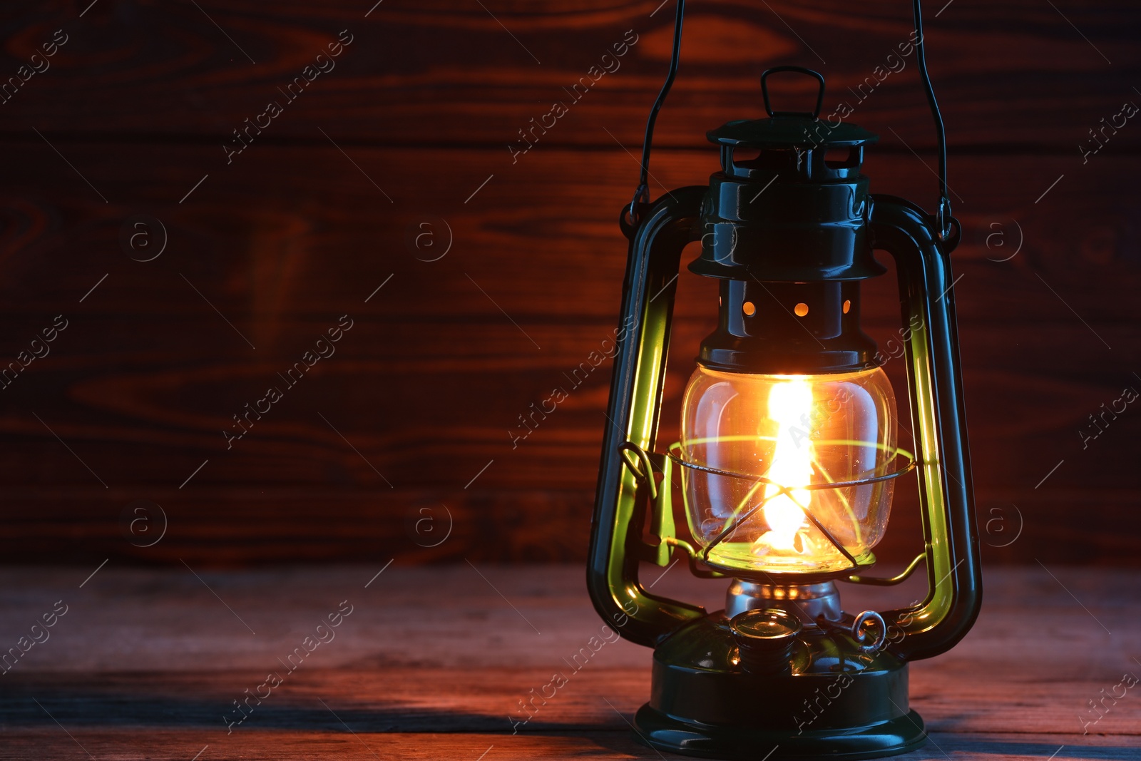Photo of One vintage kerosene lantern on wooden table, space for text