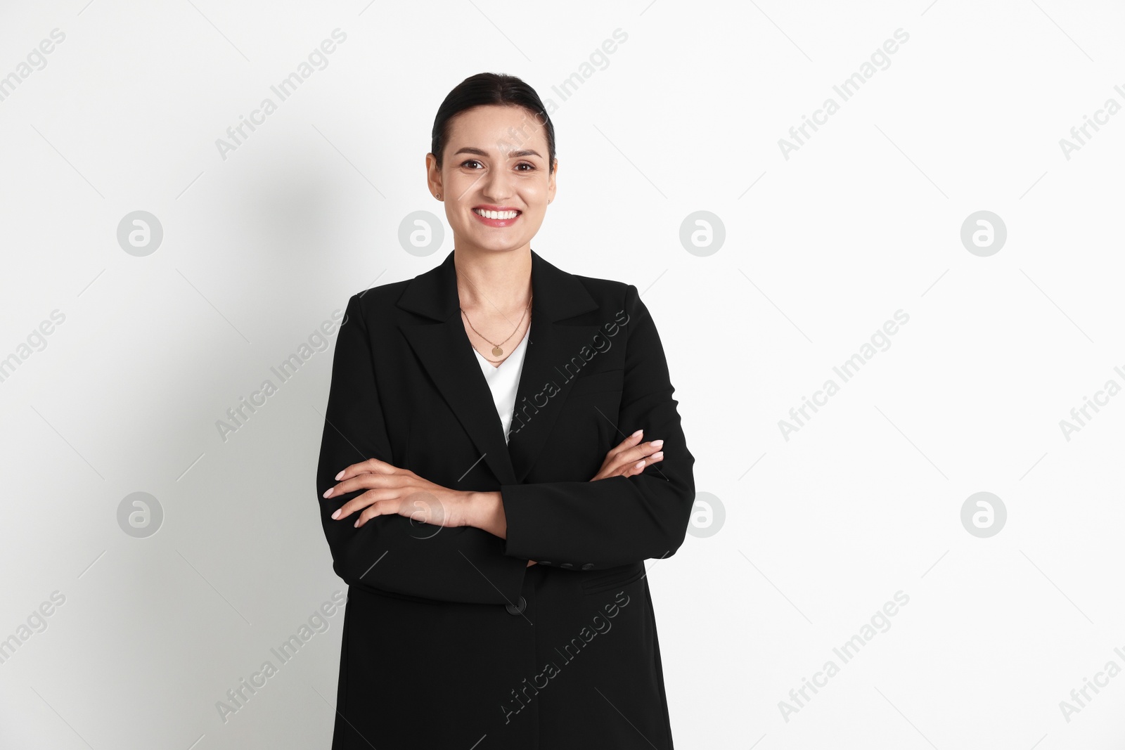 Confident business woman in suit on light background Photo of Confident business woman in suit on light background