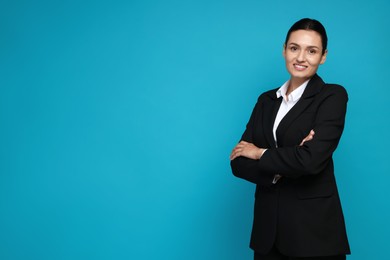Photo of Confident business woman in suit on light blue background. Space for text
