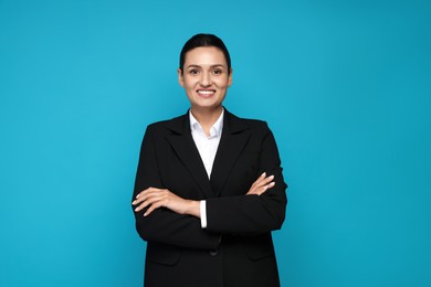 Photo of Confident business woman in suit on light blue background