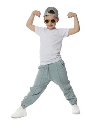 Photo of Cute little boy in sunglasses and baseball hat dancing on white background