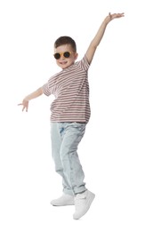 Photo of Happy little boy in sunglasses dancing on white background