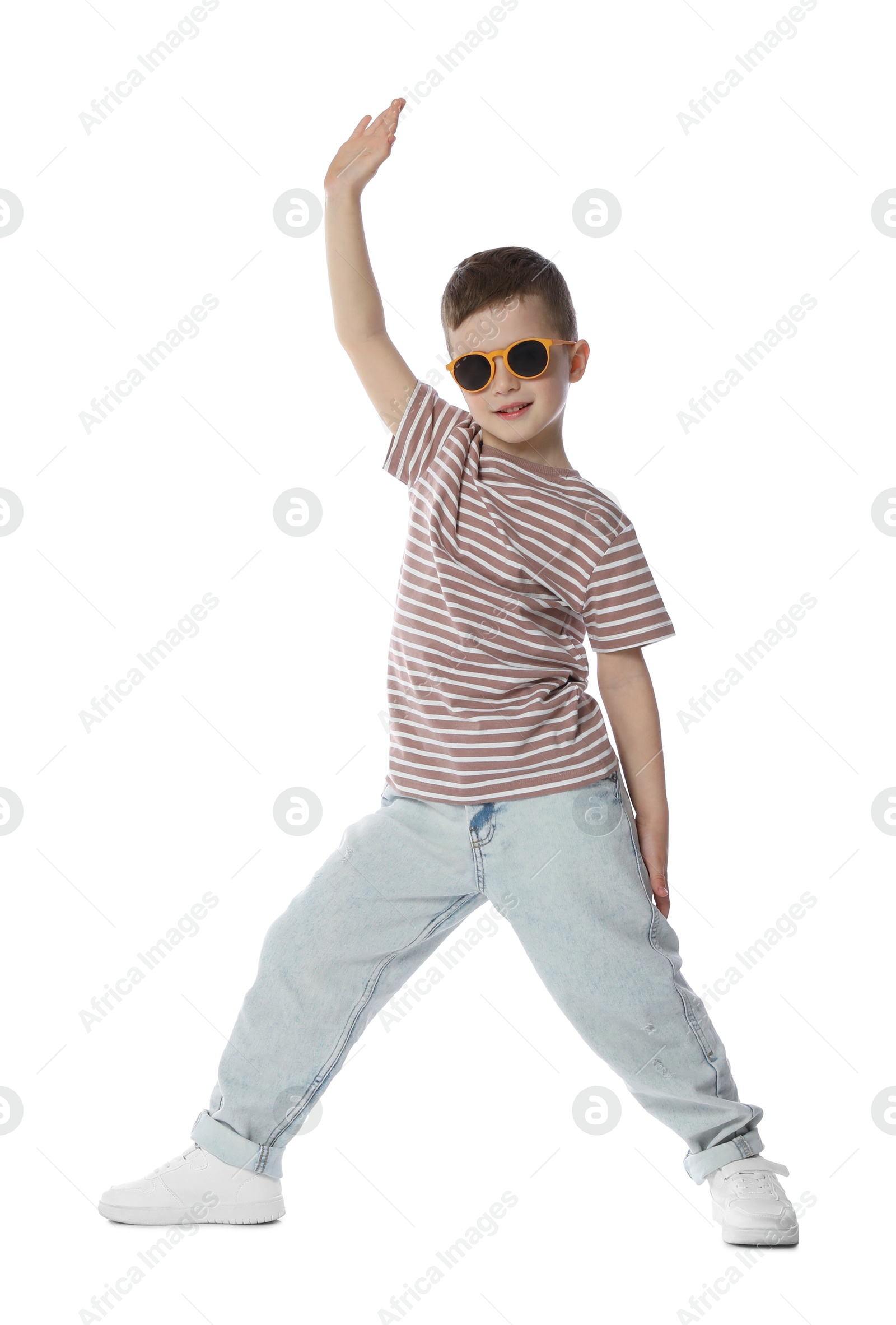 Happy little boy in sunglasses dancing on white background Photo of Happy little boy in sunglasses dancing on white background