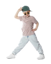 Photo of Happy little boy in sunglasses and baseball hat dancing on white background