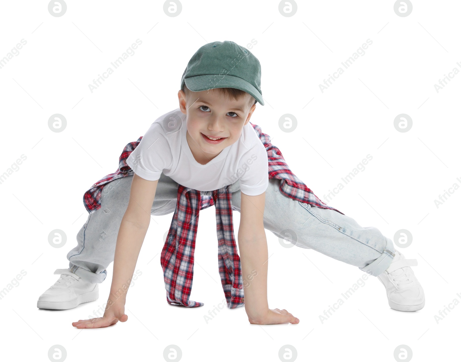 Photo of Happy little boy in baseball hat dancing on white background