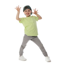 Photo of Happy little boy in baseball hat dancing on white background