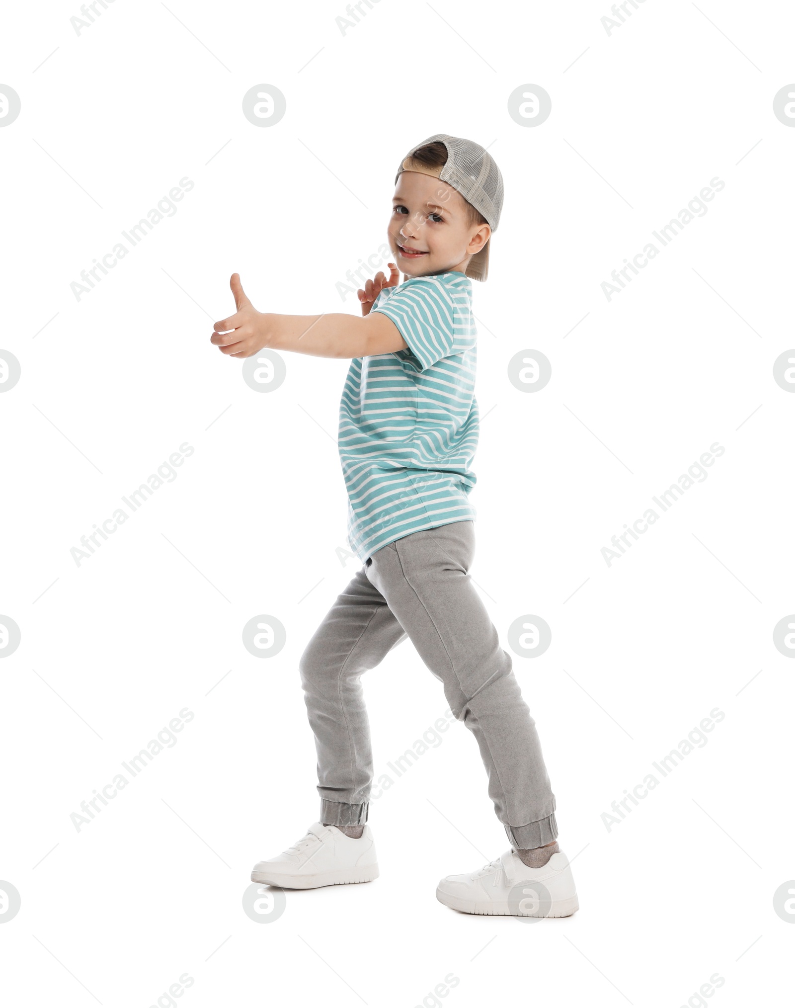Happy little boy in baseball hat dancing on white background Photo of Happy little boy in baseball hat dancing on white background
