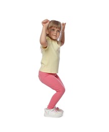 Photo of Cute little girl dancing on white background