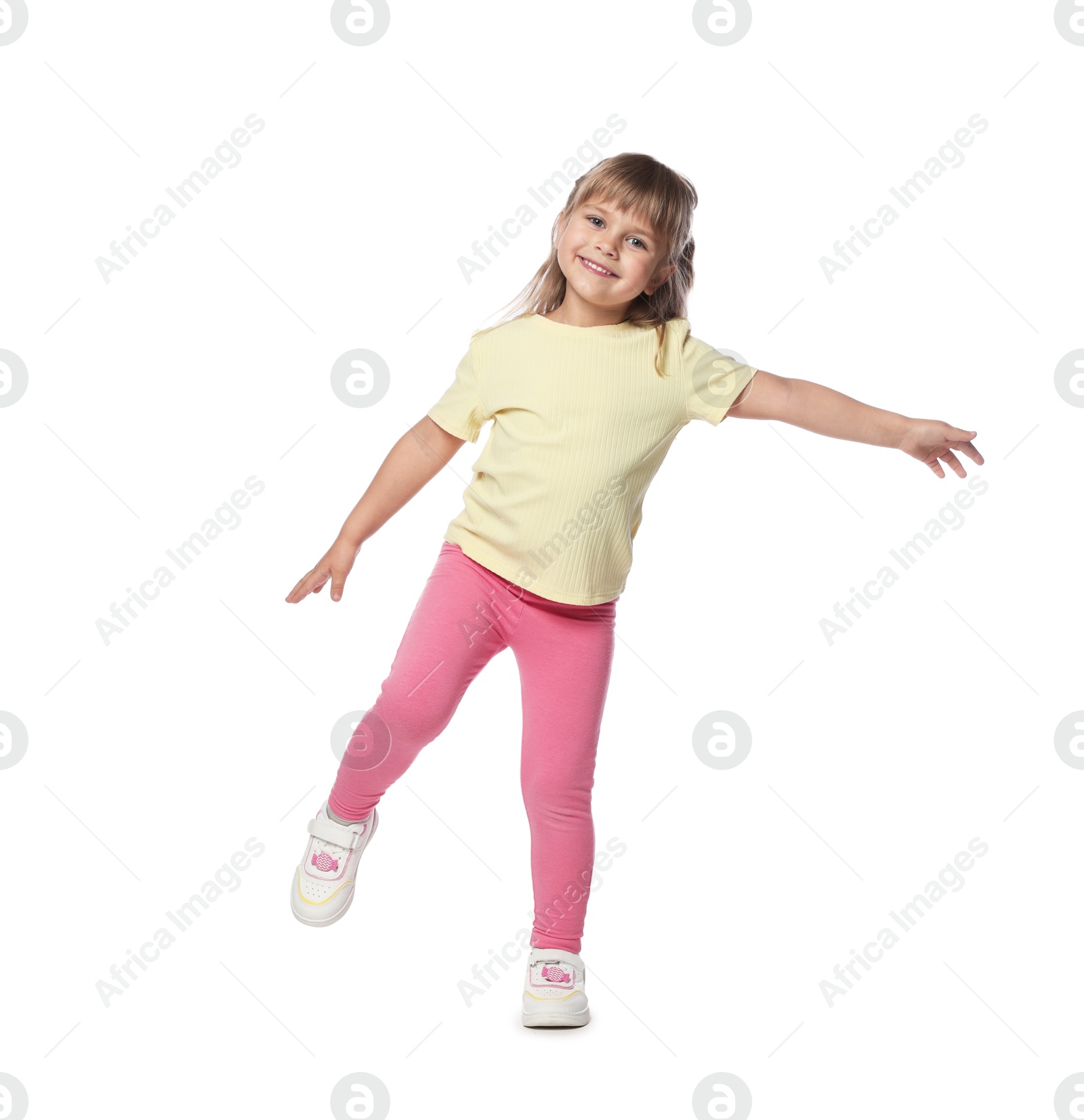 Happy little girl dancing on white background Photo of Happy little girl dancing on white background