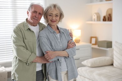 Photo of Portrait of lovely senior couple at home, space for text