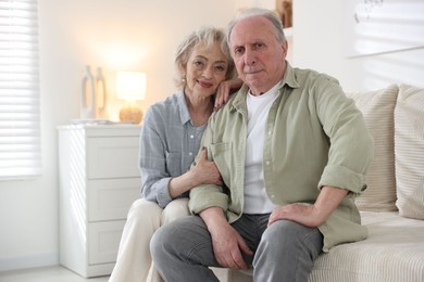 Photo of Lovely senior couple on sofa at home