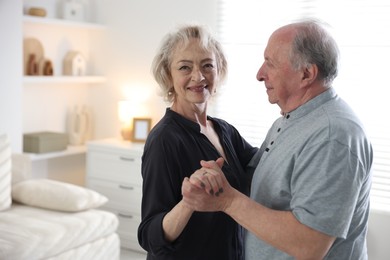 Photo of Lovely senior couple at home, space for text