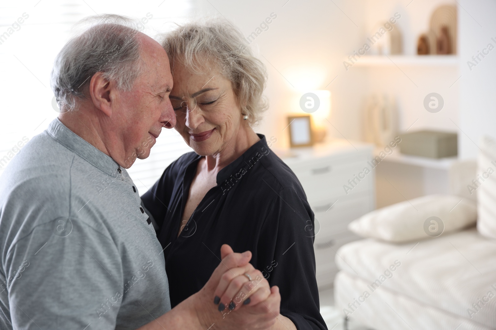 Lovely senior couple at home, space for text Photo of Lovely senior couple at home, space for text