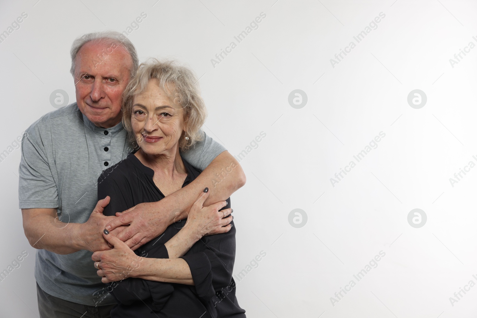 Portrait of lovely senior couple on white background, space for text Photo of Portrait of lovely senior couple on white background, space for text