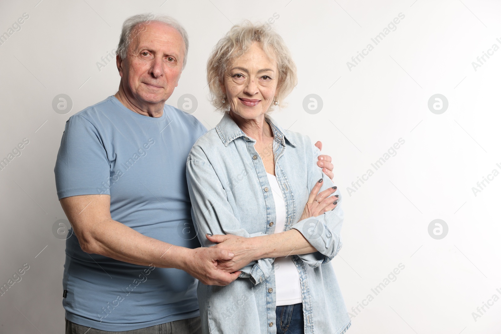 Portrait of lovely senior couple on white background, space for text Photo of Portrait of lovely senior couple on white background, space for text