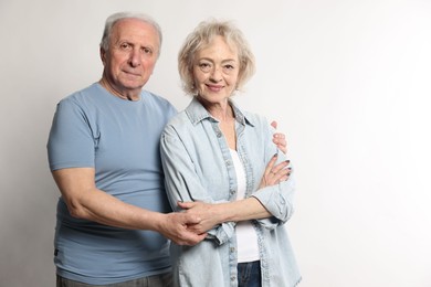 Photo of Portrait of lovely senior couple on white background, space for text
