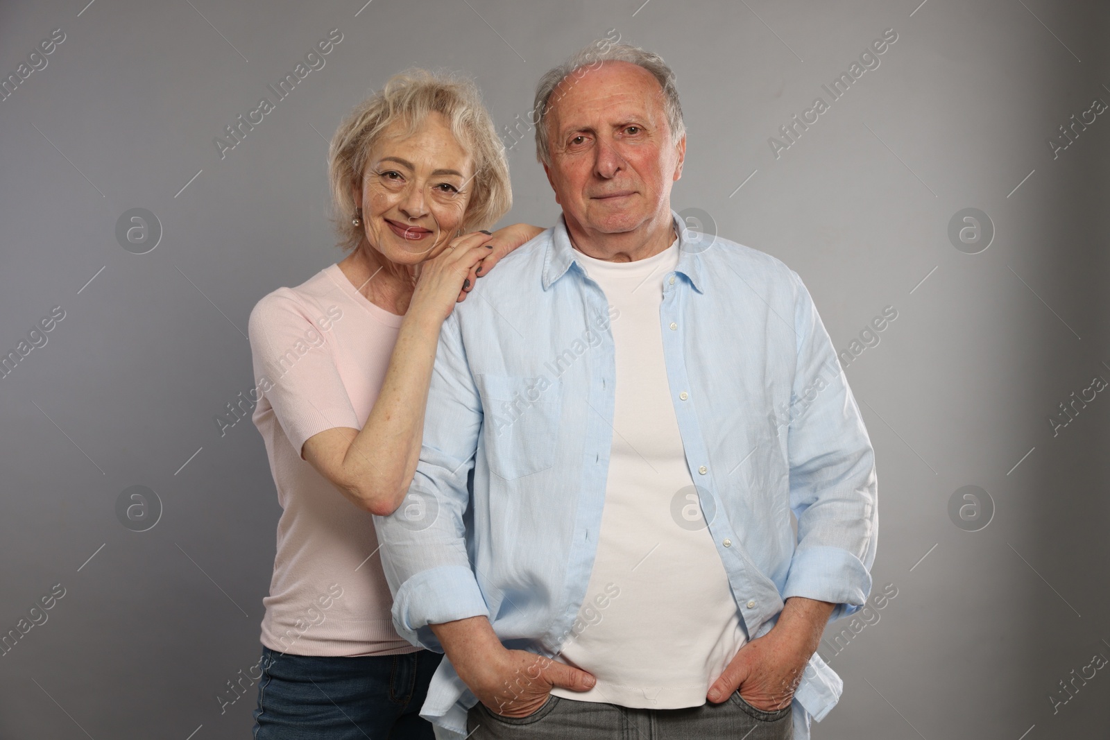 Photo of Portrait of lovely senior couple on grey background