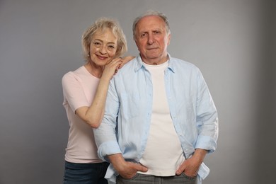 Photo of Portrait of lovely senior couple on grey background