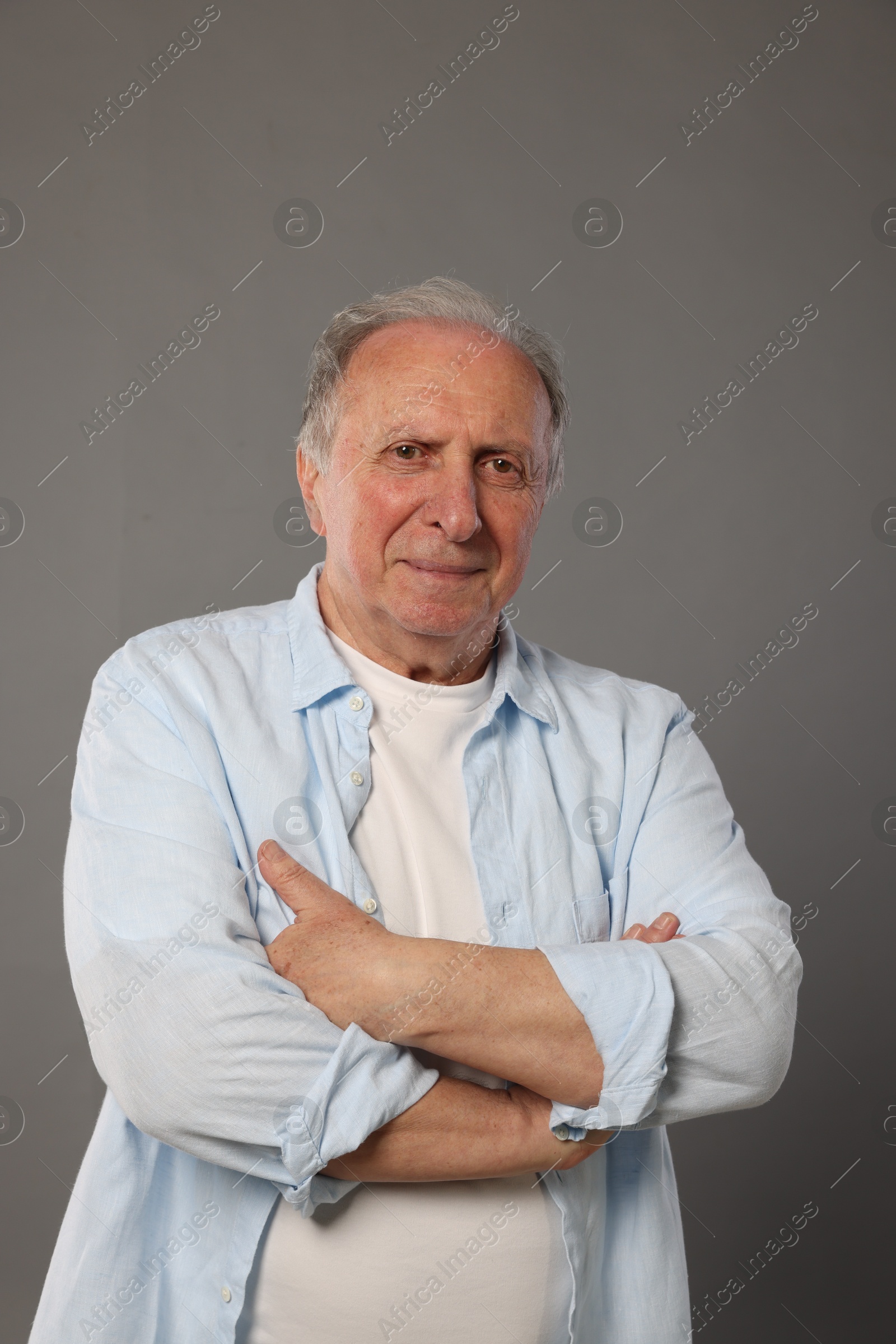 Photo of Portrait of senior man on grey background