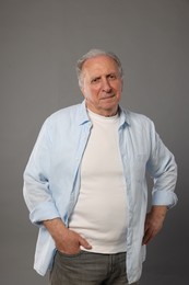 Photo of Portrait of senior man on grey background