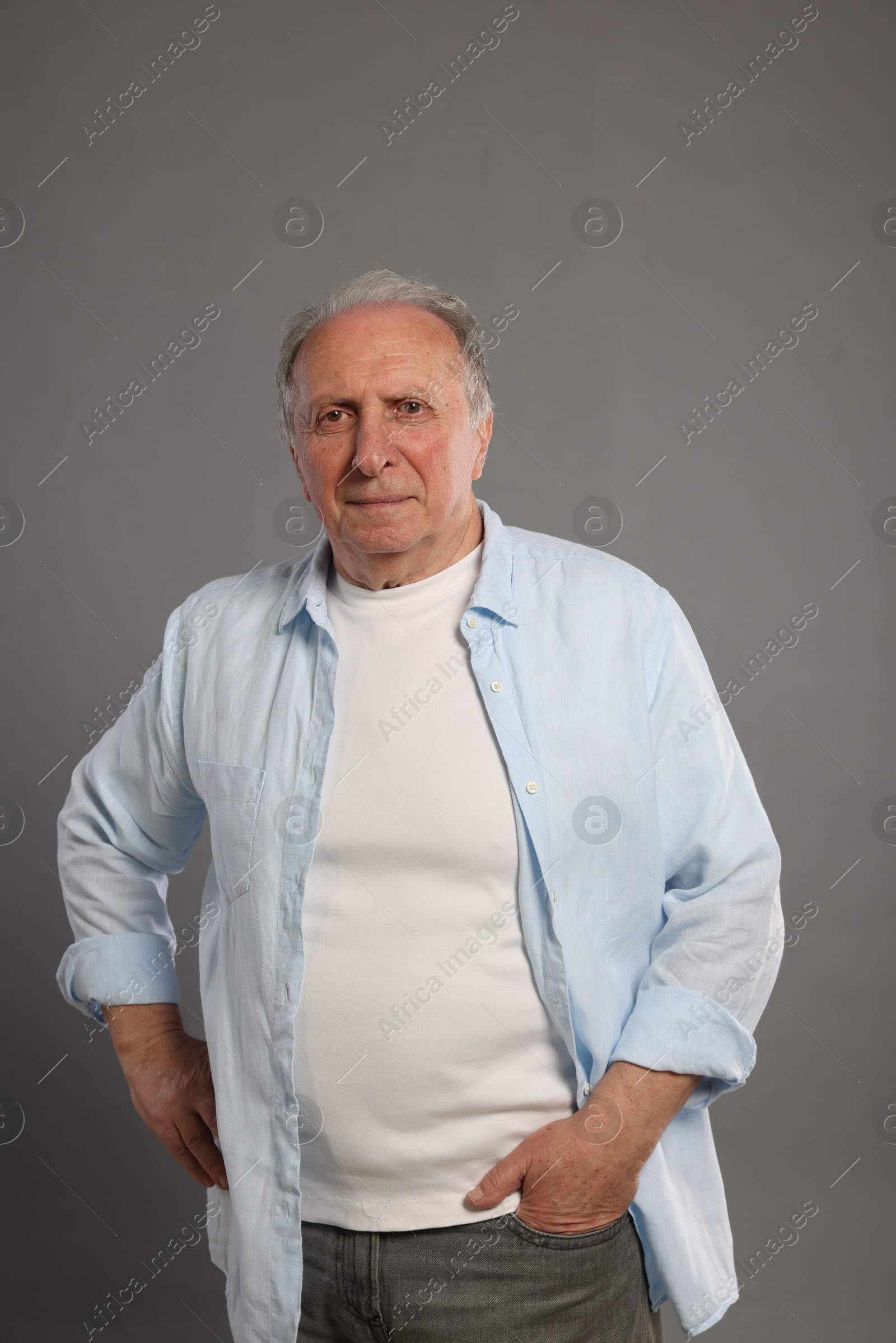 Photo of Portrait of senior man on grey background