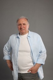 Photo of Portrait of senior man on grey background