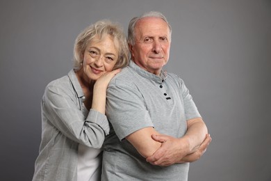 Photo of Portrait of lovely senior couple on grey background