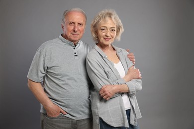 Photo of Portrait of lovely senior couple on grey background