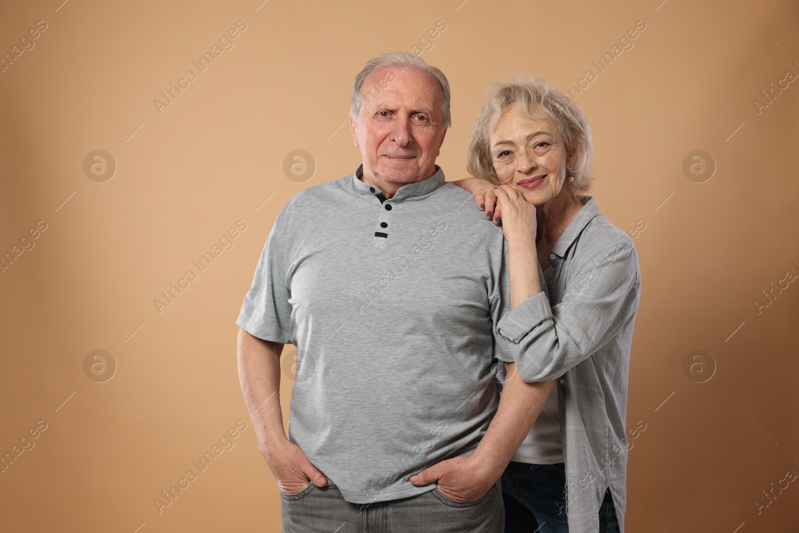 Photo of Portrait of lovely senior couple on beige background