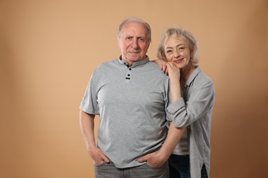Photo of Portrait of lovely senior couple on beige background