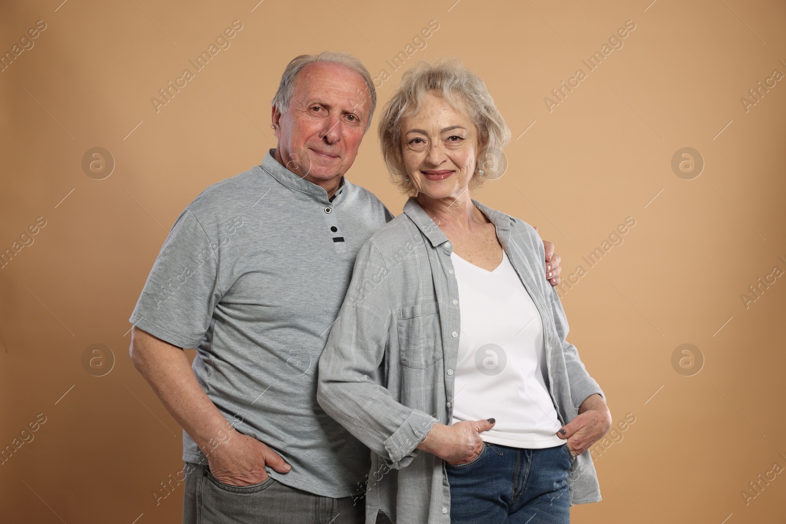 Photo of Portrait of lovely senior couple on beige background