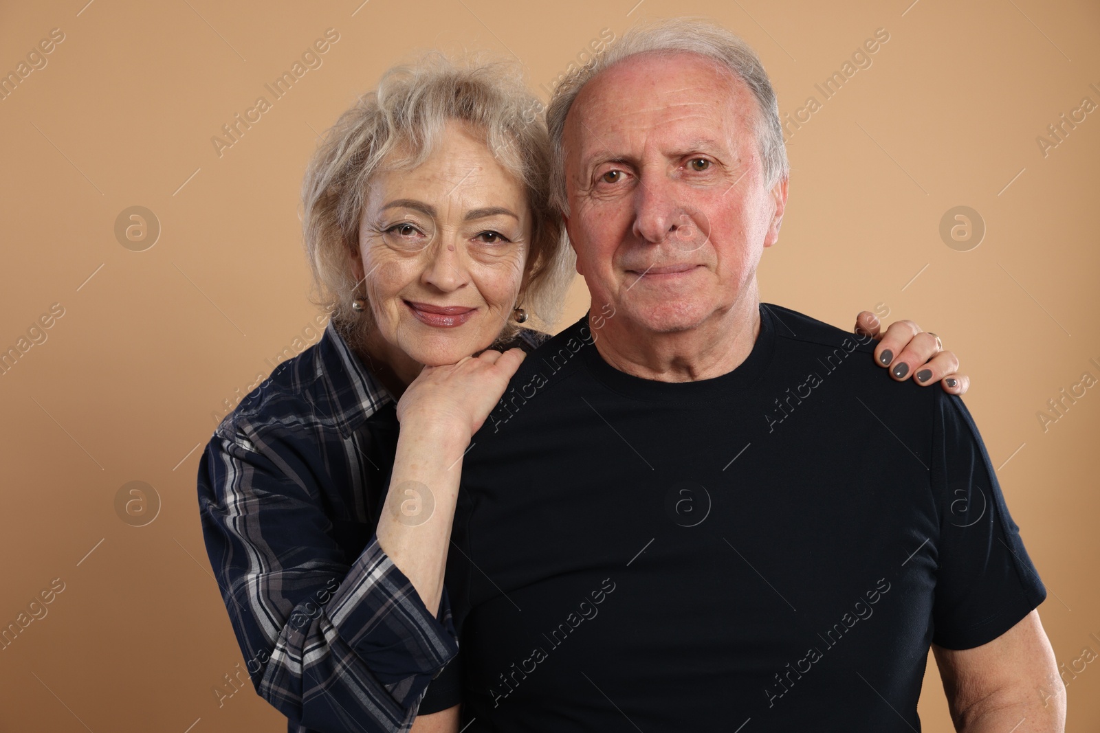 Photo of Portrait of lovely senior couple on beige background