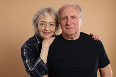 Photo of Portrait of lovely senior couple on beige background