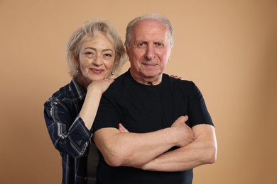 Photo of Portrait of lovely senior couple on beige background