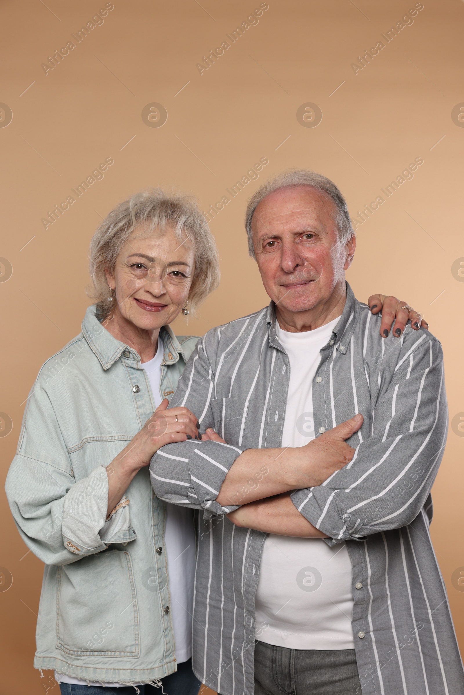 Photo of Portrait of lovely senior couple on beige background