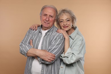 Photo of Portrait of lovely senior couple on beige background