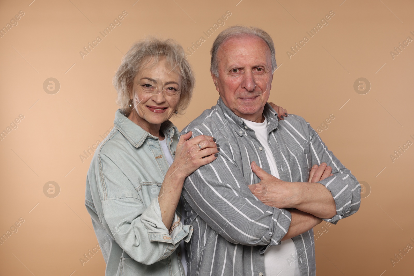Photo of Portrait of lovely senior couple on beige background