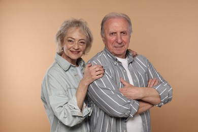 Photo of Portrait of lovely senior couple on beige background