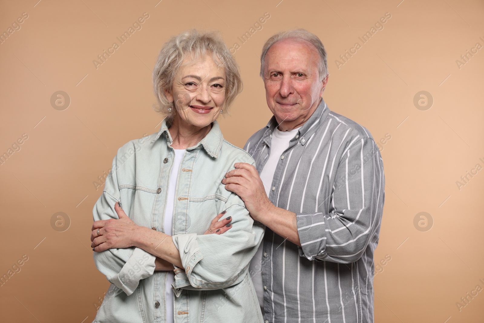Portrait of lovely senior couple on beige background Photo of Portrait of lovely senior couple on beige background