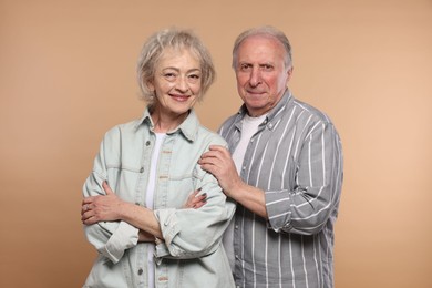 Photo of Portrait of lovely senior couple on beige background