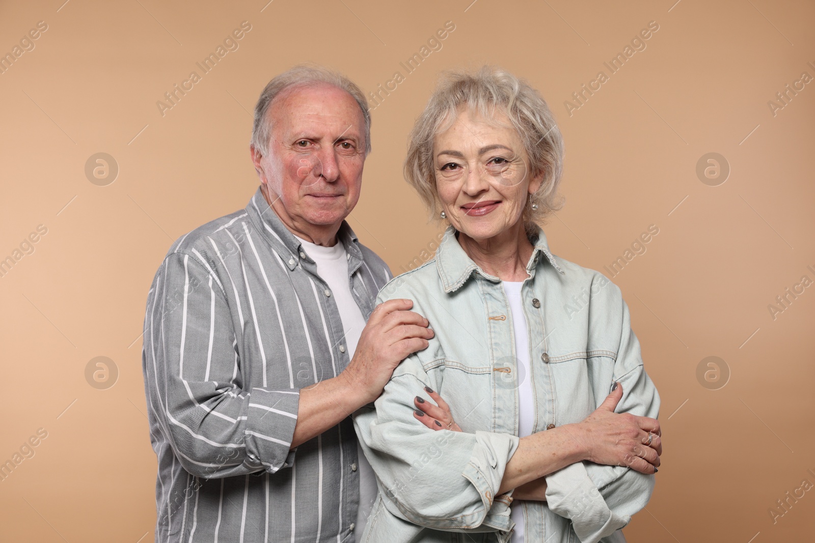 Portrait of lovely senior couple on beige background Photo of Portrait of lovely senior couple on beige background