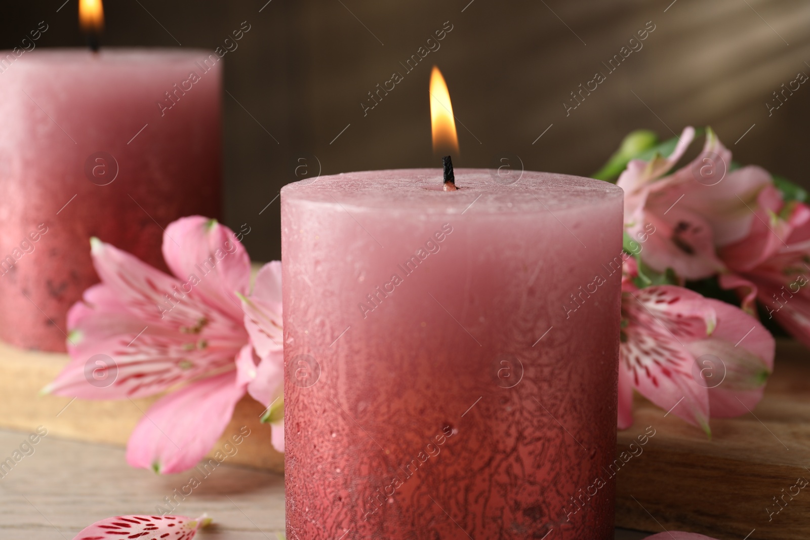 Burning candles and lily flowers on white wooden table, closeup Photo of Burning candles and lily flowers on white wooden table, closeup