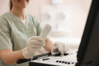 Photo of Professional sonographer with ultrasound machine in clinic, closeup