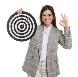 Photo of Targeting. Smiling businesswoman with dart board showing ok gesture on white background