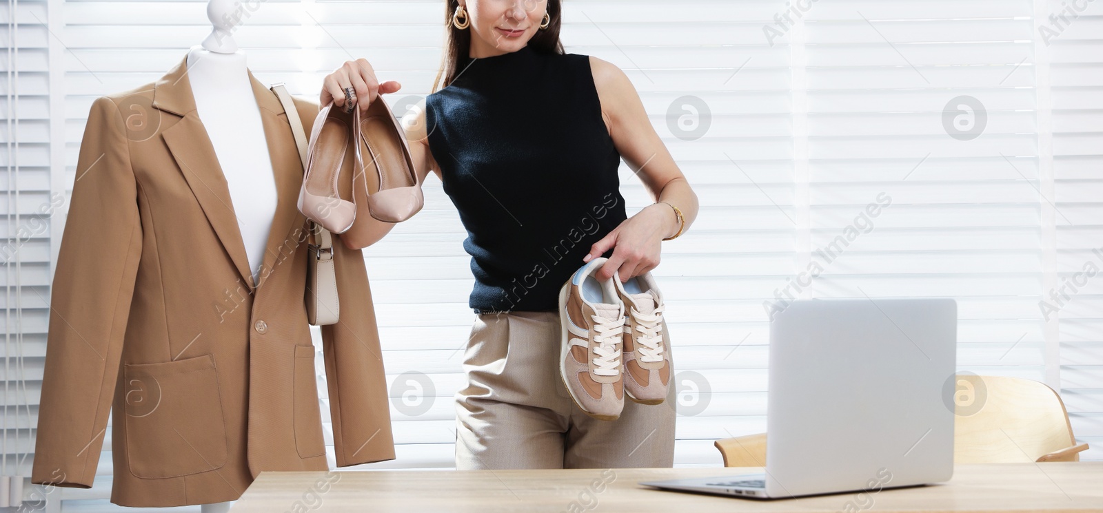 Professional stylist having online consultation with client via laptop indoors Photo of Professional stylist having online consultation with client via laptop indoors